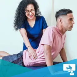 Female clinician assisting a patient with prone lumbar extension