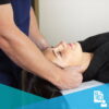 Female patient receiving a neck treatment from a chiropractor