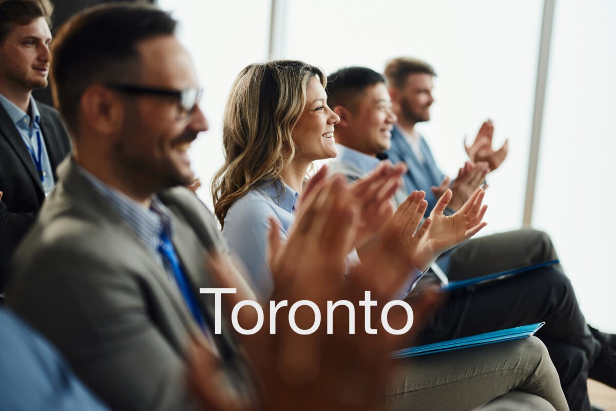 Chiropractors applauding at a continuing education seminar in Toronto