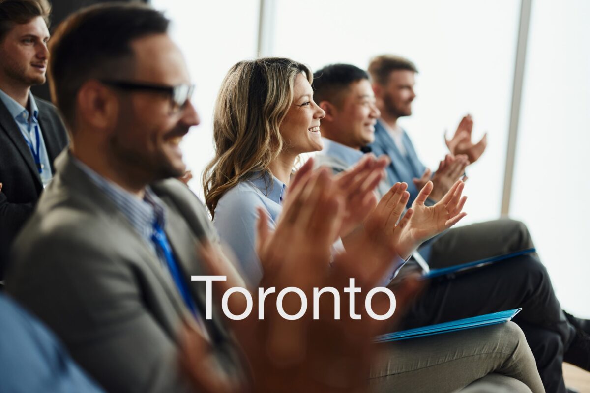 Chiropractors applauding at a continuing education seminar in Toronto