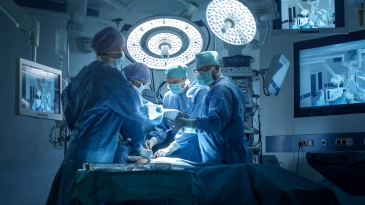 Medical Team Performing Spinal Surgical Operation in Modern Operating Room