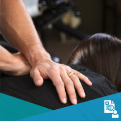 A chiropractor's hands on a patient's thoracic spine