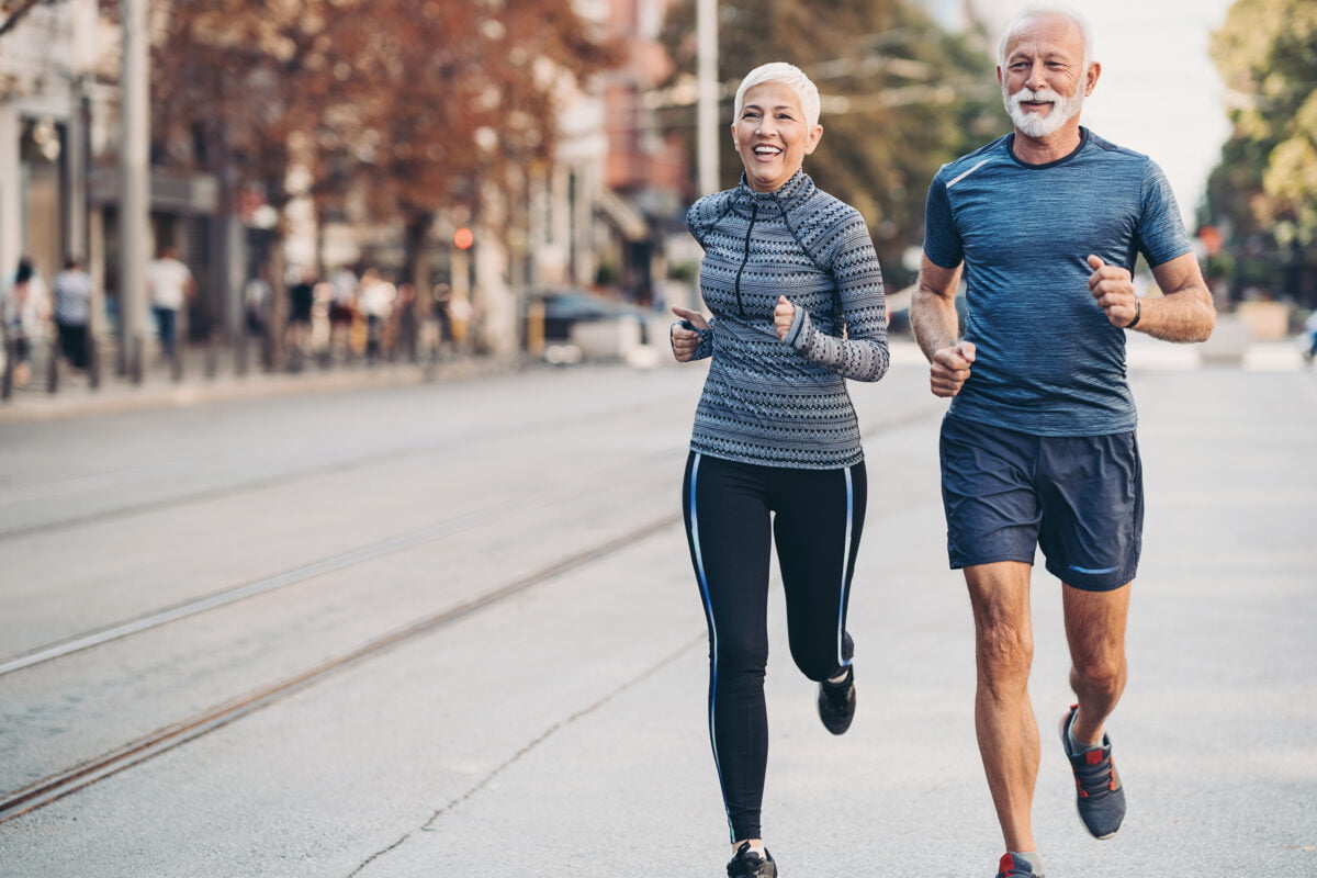 Two seniors jogging outdoors in the city
