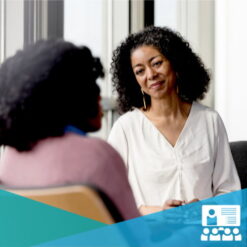 Mature female clinician sitting listening to a patient / Mastering the Biopsychosocial Approach