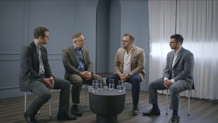 Dr. Thistle and 3 male colleagues sitting having a discussion about the biopsychosocial model