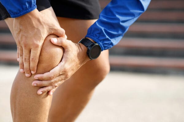 Runner with knee pain at the running track