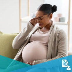 A young black pregnant woman in pain from a migraine headache