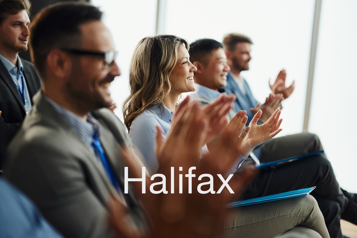 Chiropractors applauding at a continuing education seminar in Halifax